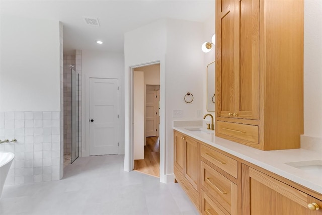 837 Birch Ln, Cottonwood Shores, TX 78657 - full bathroom featuring a shower stall, double vanity, a freestanding bath, a closet, and tile walls