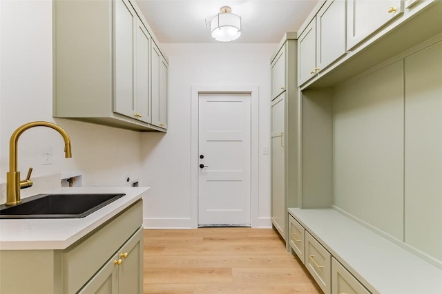 837 Birch Ln, Cottonwood Shores, TX 78657 - washroom with cabinet space, light wood-style floors, and washer hookup