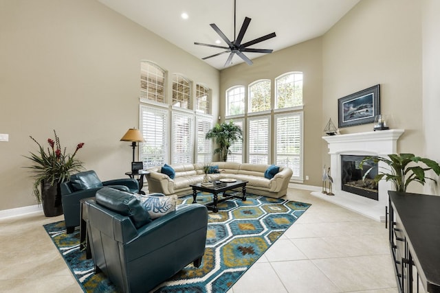 117 N Whitley Dr, Austin, TX 78738 - living room with a towering ceiling, ceiling fan, light tile patterned floors, a glass covered fireplace, and recessed lighting