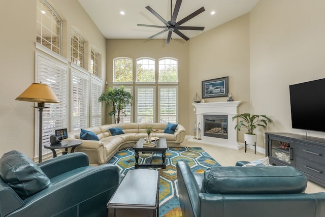 117 N Whitley Dr, Austin, TX 78738 - living area featuring high vaulted ceiling, ceiling fan, a glass covered fireplace, tile patterned flooring, and recessed lighting