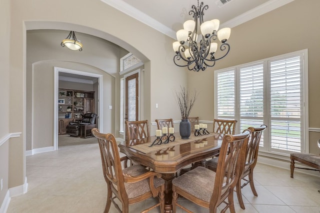117 N Whitley Dr, Austin, TX 78738 - dining room featuring arched walkways, a chandelier, light tile patterned floors, and crown molding