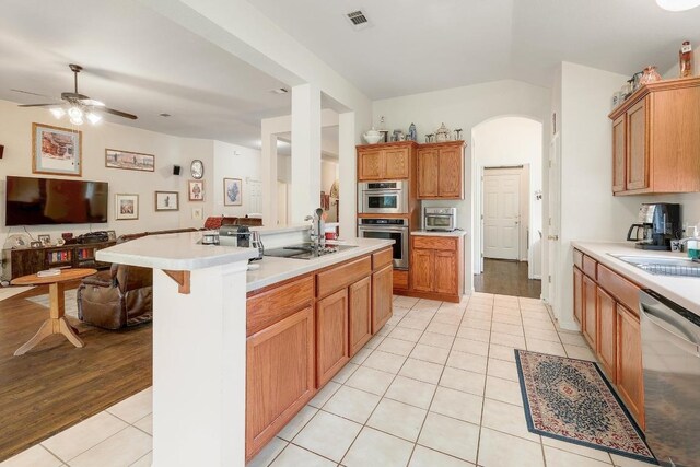 210 Buoy Cir, Georgetown, TX 78633 - kitchen featuring stainless steel dishwasher, open floor plan, light tile patterned floors, light countertops, and a ceiling fan