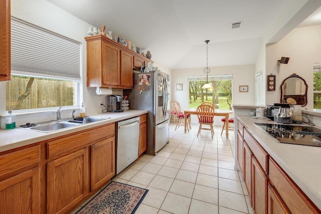 210 Buoy Cir, Georgetown, TX 78633 - kitchen featuring appliances with stainless steel finishes, light countertops, light tile patterned flooring, vaulted ceiling, and pendant lighting