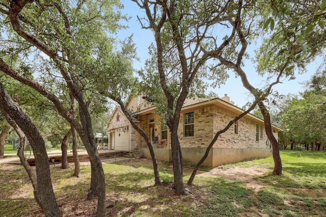 210 Buoy Cir, Georgetown, TX 78633 - view of side of home with a chimney, brick siding, and a lawn
