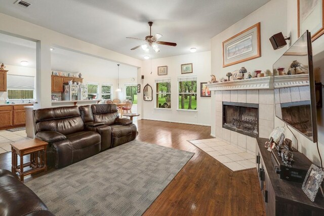 210 Buoy Cir, Georgetown, TX 78633 - living room with ceiling fan, wood finished floors, healthy amount of natural light, and a fireplace