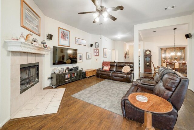 210 Buoy Cir, Georgetown, TX 78633 - living area with a ceiling fan, wood finished floors, and a tiled fireplace