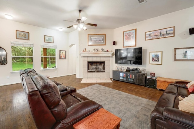 210 Buoy Cir, Georgetown, TX 78633 - living room featuring wood finished floors, a ceiling fan, a fireplace, and arched walkways