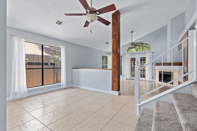 1102 Forest Oaks Path, Cedar Park, TX 78613 - tiled empty room featuring ceiling fan, a textured ceiling, stairway, and french doors