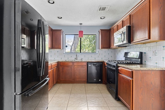 1102 Forest Oaks Path, Cedar Park, TX 78613 - kitchen with black appliances, backsplash, a textured ceiling, light tile patterned floors, and decorative light fixtures