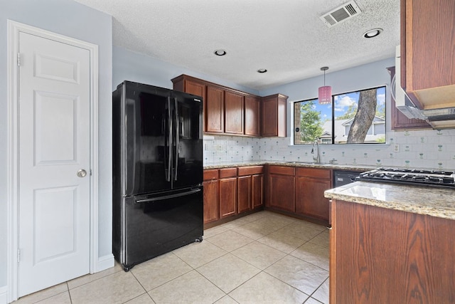 1102 Forest Oaks Path, Cedar Park, TX 78613 - kitchen featuring freestanding refrigerator, decorative backsplash, light tile patterned flooring, light stone counters, and a textured ceiling