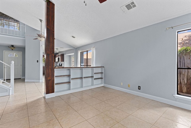 1102 Forest Oaks Path, Cedar Park, TX 78613 - unfurnished room with a ceiling fan, lofted ceiling, light tile patterned floors, and a textured ceiling