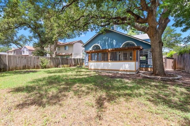 1102 Forest Oaks Path, Cedar Park, TX 78613 - rear view of property featuring a fenced backyard and a sunroom