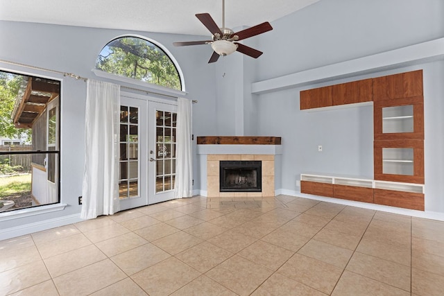 1102 Forest Oaks Path, Cedar Park, TX 78613 - unfurnished living room with french doors, tile patterned flooring, high vaulted ceiling, ceiling fan, and a tiled fireplace