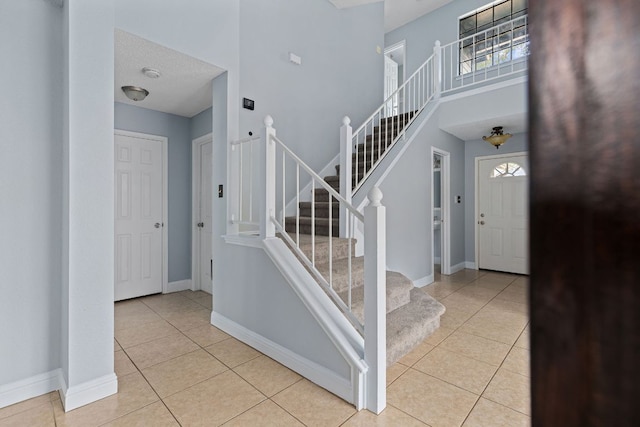 1102 Forest Oaks Path, Cedar Park, TX 78613 - stairs featuring tile patterned flooring and a towering ceiling