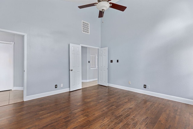1102 Forest Oaks Path, Cedar Park, TX 78613 - spare room featuring a towering ceiling, a ceiling fan, and wood finished floors