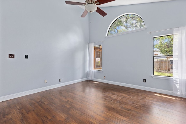1102 Forest Oaks Path, Cedar Park, TX 78613 - empty room with a ceiling fan, dark wood-type flooring, and a towering ceiling