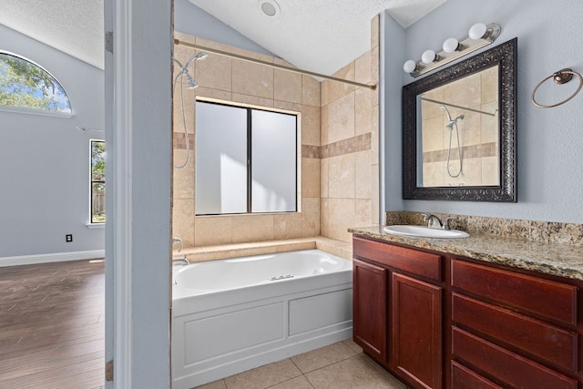 1102 Forest Oaks Path, Cedar Park, TX 78613 - full bathroom with a textured ceiling, a garden tub, lofted ceiling, vanity, and tiled shower