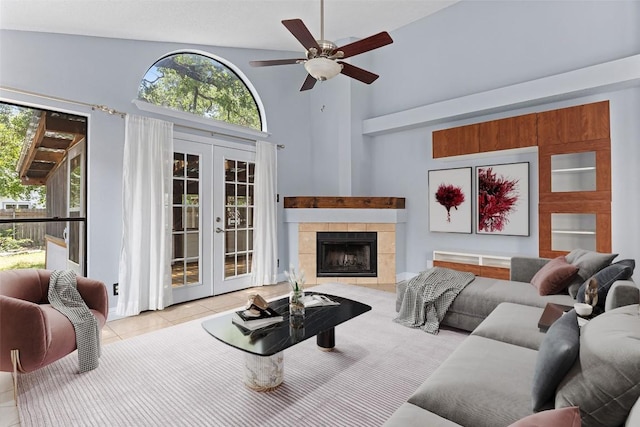 1102 Forest Oaks Path, Cedar Park, TX 78613 - living room featuring french doors, high vaulted ceiling, a ceiling fan, tile patterned flooring, and a tile fireplace