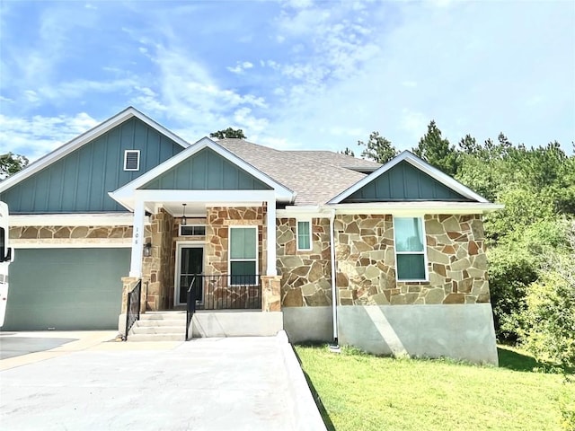 108 W Keamuku Ct, Bastrop, TX 78602 - view of front of home featuring stone siding, a garage, board and batten siding, roof with shingles, and concrete driveway