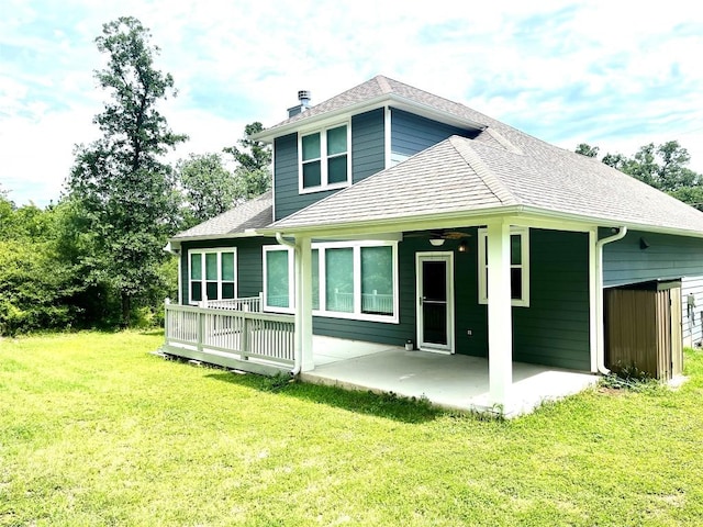 108 W Keamuku Ct, Bastrop, TX 78602 - rear view of property featuring a patio area, a yard, a chimney, a ceiling fan, and roof with shingles