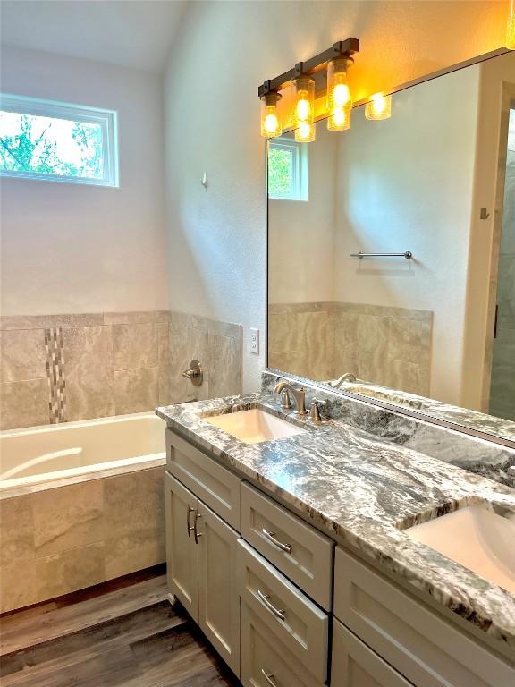 108 W Keamuku Ct, Bastrop, TX 78602 - full bath featuring plenty of natural light, double vanity, and a bath