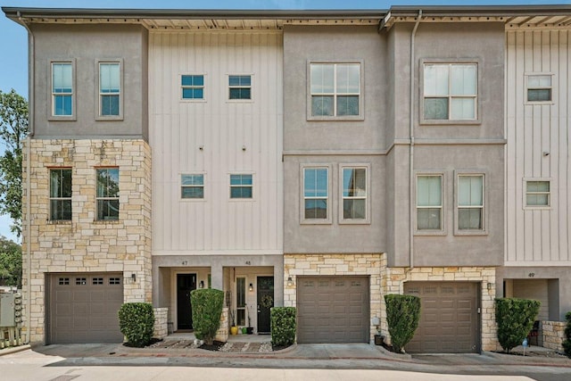2520 Bluebonnet Ln Unit 48, Austin, TX 78704 - view of property featuring stone siding, an attached garage, board and batten siding, and stucco siding