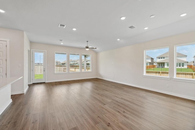 1754 Sawmill Xing, Round Rock, TX 78665 - unfurnished living room featuring wood finished floors, a ceiling fan, and recessed lighting