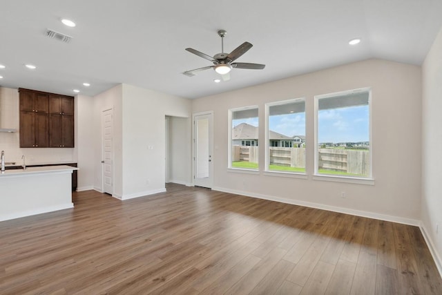1754 Sawmill Xing, Round Rock, TX 78665 - unfurnished living room featuring a ceiling fan, wood finished floors, and recessed lighting