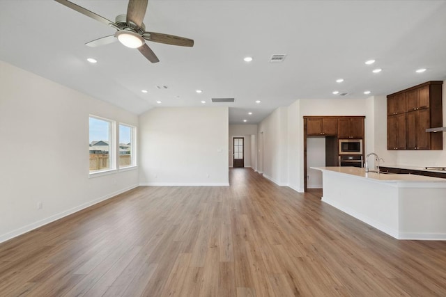1754 Sawmill Xing, Round Rock, TX 78665 - unfurnished living room featuring light wood-type flooring, a ceiling fan, recessed lighting, and vaulted ceiling