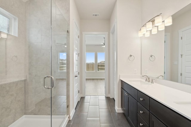 1754 Sawmill Xing, Round Rock, TX 78665 - bathroom with double vanity, a shower stall, tile patterned flooring, and a ceiling fan