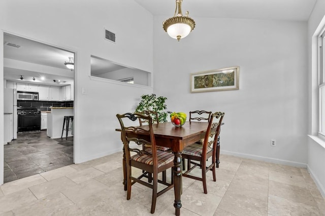 1305 Doonesbury Dr, Austin, TX 78758 - dining area with baseboards and a towering ceiling