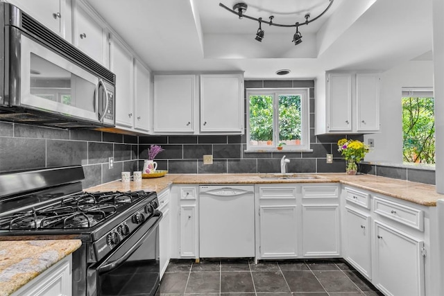 1305 Doonesbury Dr, Austin, TX 78758 - kitchen featuring gas stove, white dishwasher, stainless steel microwave, and plenty of natural light