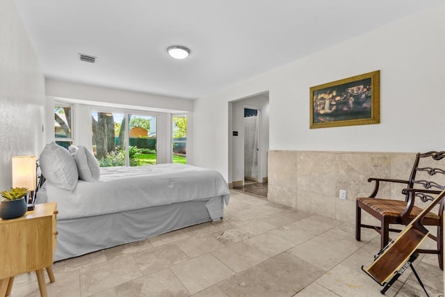 1305 Doonesbury Dr, Austin, TX 78758 - bedroom featuring tile walls