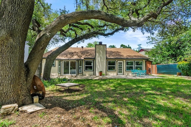 1305 Doonesbury Dr, Austin, TX 78758 - back of property featuring a chimney and a patio area