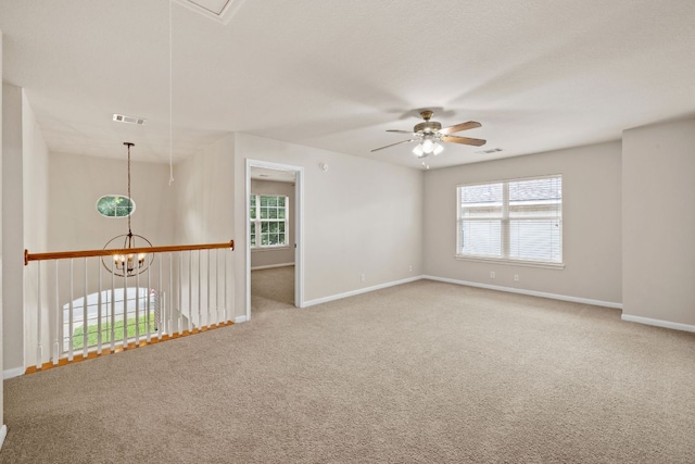 2732 Cascade Falls Dr, Austin, TX 78738 - empty room featuring a ceiling fan, carpet flooring, healthy amount of natural light, and a chandelier