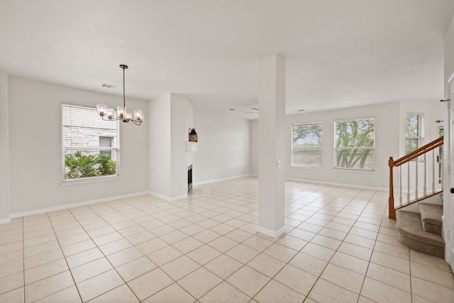 2732 Cascade Falls Dr, Austin, TX 78738 - unfurnished living room featuring a chandelier, healthy amount of natural light, light tile patterned floors, and stairway