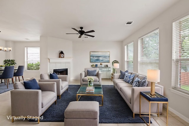 2732 Cascade Falls Dr, Austin, TX 78738 - tiled living room featuring plenty of natural light, ceiling fan, a fireplace, and a chandelier