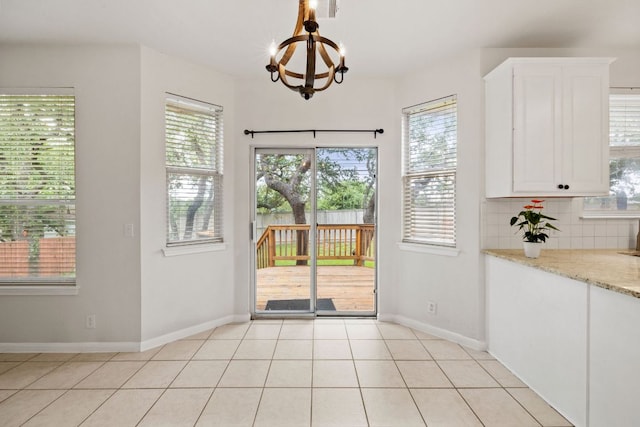 2732 Cascade Falls Dr, Austin, TX 78738 - doorway with healthy amount of natural light, a chandelier, and light tile patterned floors