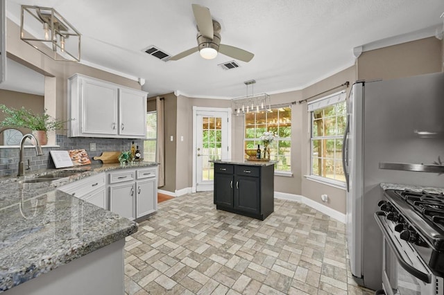 8305 Hillrock Dr, Round Rock, TX 78681 - kitchen featuring decorative backsplash, brick patterned floors, stainless steel gas range, white cabinets, and a ceiling fan