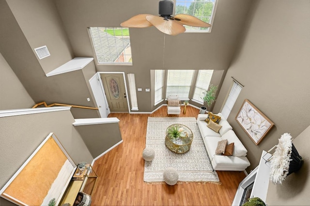 8305 Hillrock Dr, Round Rock, TX 78681 - living room featuring a high ceiling, wood finished floors, and a ceiling fan