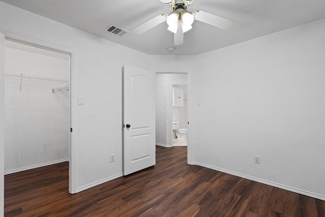 2012 Charlotte Way, Round Rock, TX 78664 - unfurnished bedroom with wood finished floors, a spacious closet, and a ceiling fan