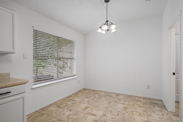 2012 Charlotte Way, Round Rock, TX 78664 - unfurnished dining area featuring a chandelier and baseboards