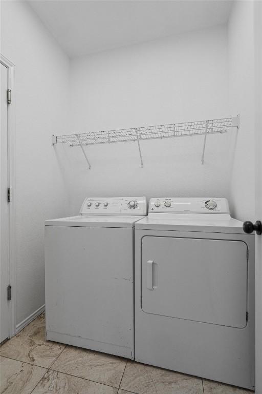 2012 Charlotte Way, Round Rock, TX 78664 - laundry area with washer and clothes dryer and light marble finish floors