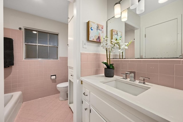 2110 Bluebonnet Ln, Austin, TX 78704 - full bath featuring tile walls, vanity, tile patterned flooring, a bathtub, and a wainscoted wall