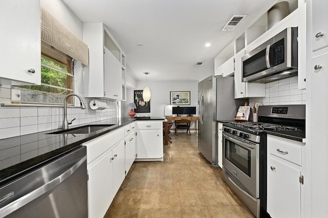 2110 Bluebonnet Ln, Austin, TX 78704 - kitchen featuring stainless steel appliances, dark countertops, white cabinets, backsplash, and recessed lighting