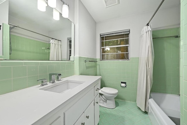 2110 Bluebonnet Ln, Austin, TX 78704 - bathroom with tile patterned flooring, tile walls, vanity, shower / bath combination with curtain, and a wainscoted wall