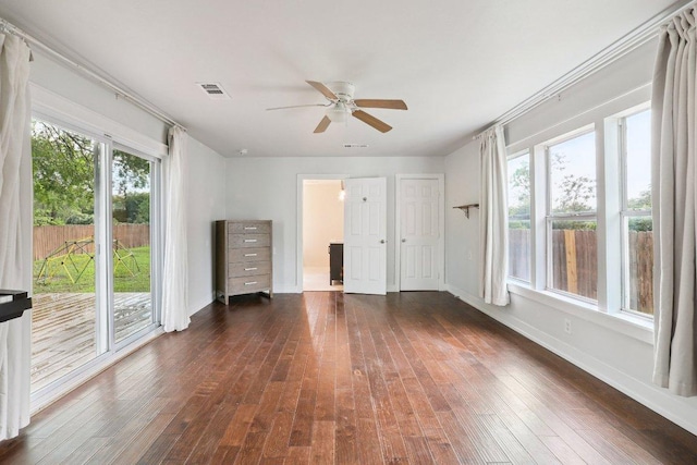 1916 Pecan St, Bastrop, TX 78602 - unfurnished bedroom featuring dark wood-style flooring, access to exterior, and a ceiling fan