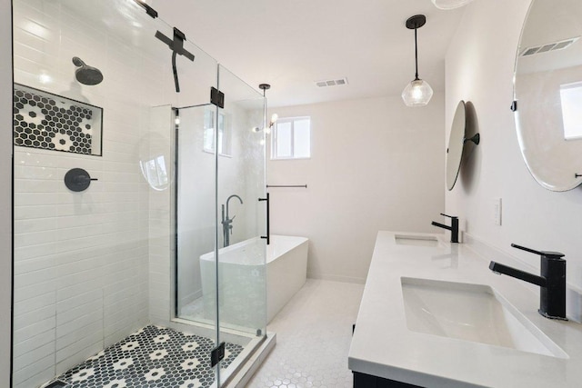 1916 Pecan St, Bastrop, TX 78602 - bathroom with a stall shower, double vanity, a freestanding bath, and tile patterned floors
