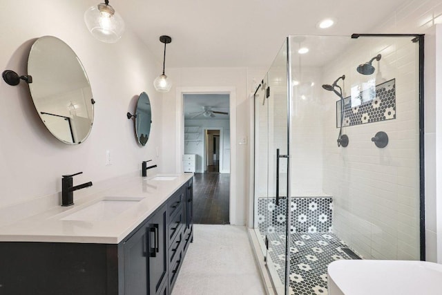 1916 Pecan St, Bastrop, TX 78602 - full bathroom with a shower stall, a ceiling fan, double vanity, and recessed lighting