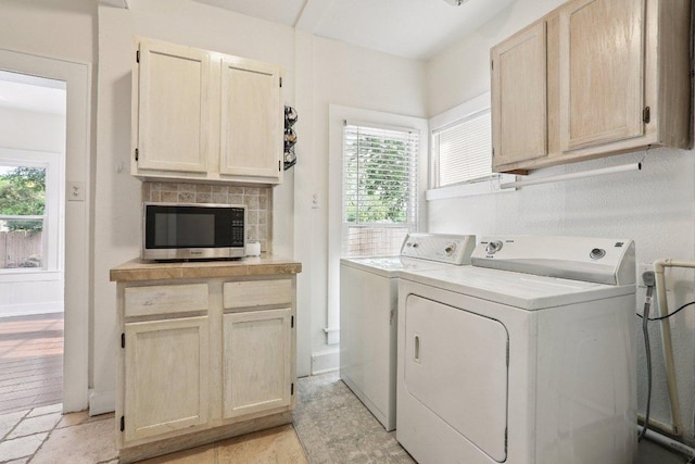1916 Pecan St, Bastrop, TX 78602 - laundry room featuring washer and dryer, cabinet space, and healthy amount of natural light